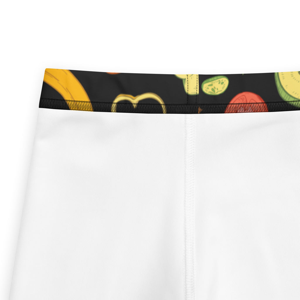 White athletic shorts with black waistband and colorful cartoon fruit pattern designed for kids buttery soft leggings