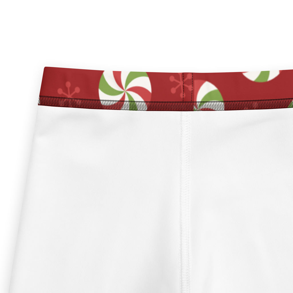 White kids christmas peppermint buttery soft leggings with festive red waistband and green and white candy swirls