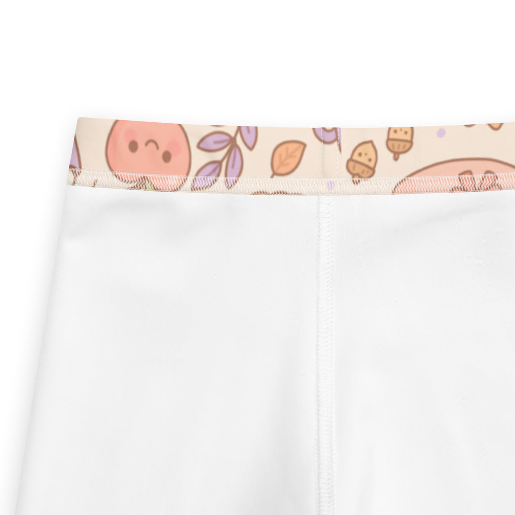 Kids cute fall themed buttery soft white leggings with pastel peach faces and autumn leaves on waistband