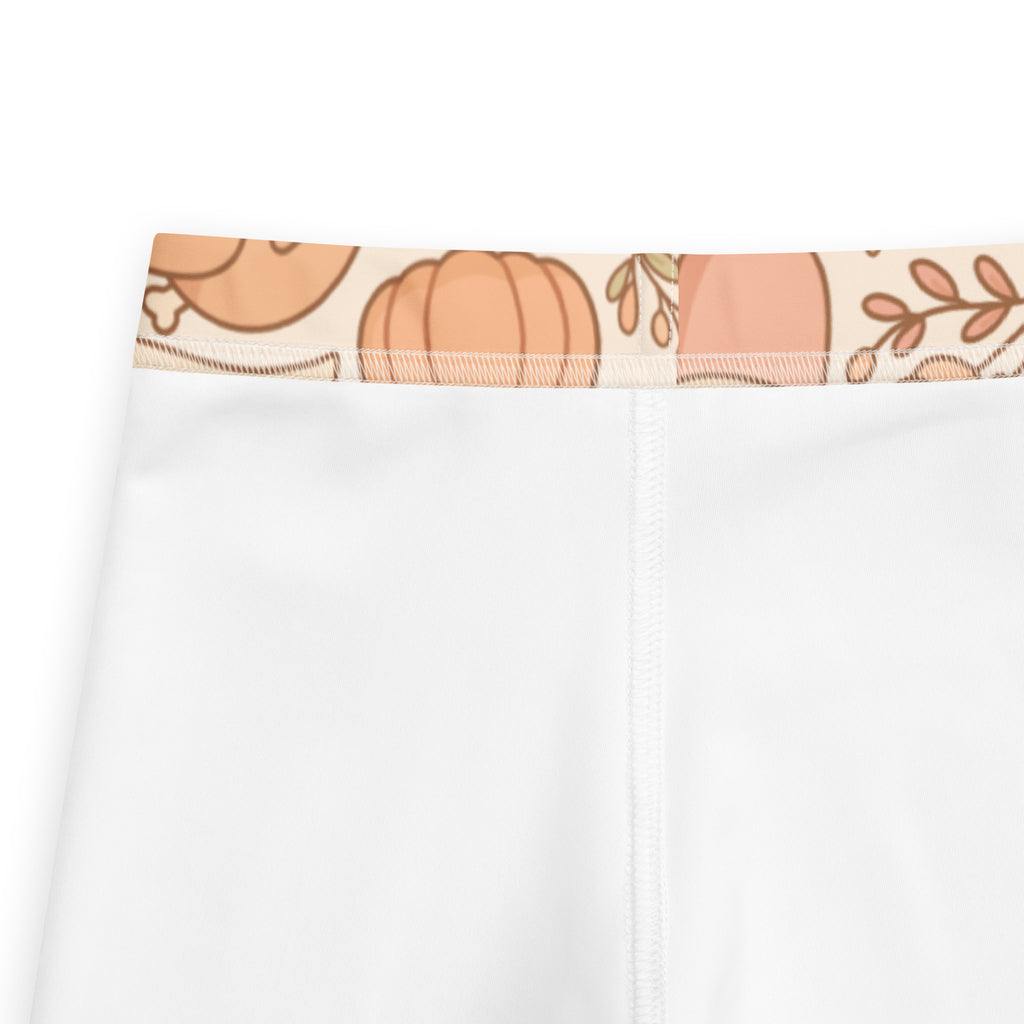 White kids thanksgiving buttery soft leggings with decorative waistband featuring peach and brown cartoon pumpkins and leaves