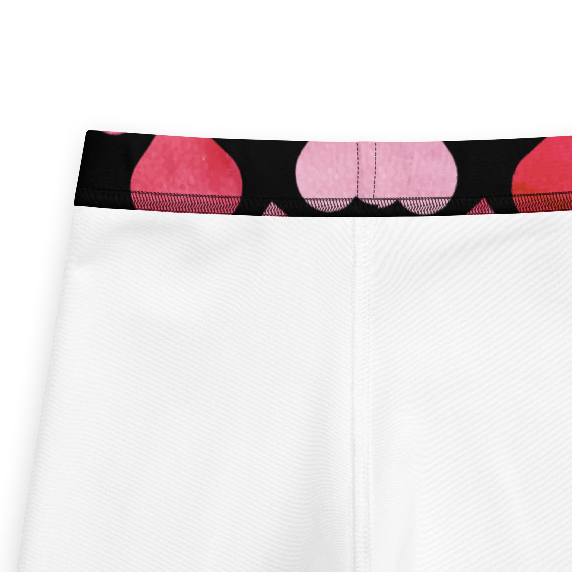 Girls black heart buttery soft leggings shown as white athletic shorts with black waistband and pink abstract circles