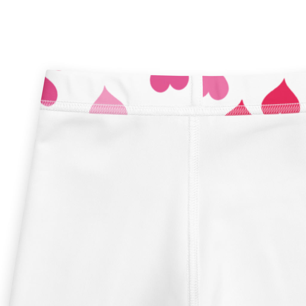 Girls Valentine’s Day white buttery soft leggings with pink heart shaped teardrops pattern along the waistband