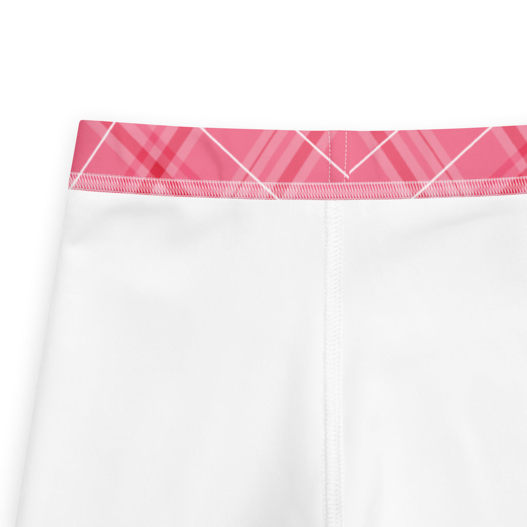 Girls pink plaid buttery soft leggings featuring white fabric with a pink plaid waistband for comfortable wear