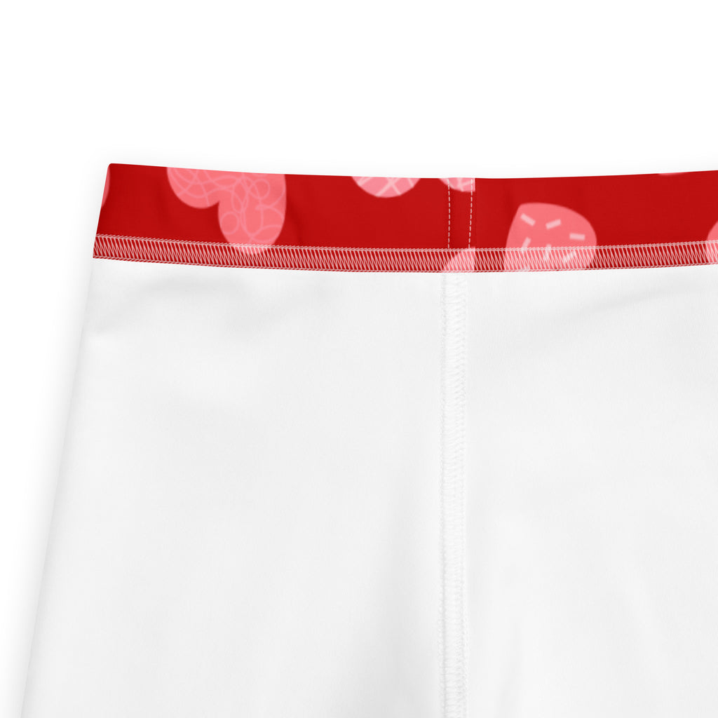 Girls red heart pattern leggings with white buttery soft material and red waistband featuring pink hearts