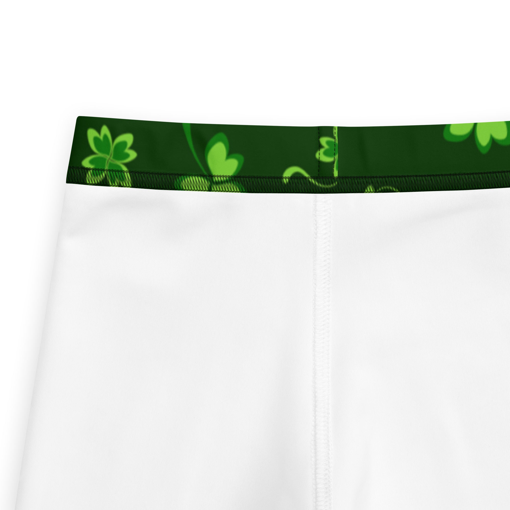 Girls green lucky clover buttery soft leggings in white shorts with dark green waistband and lime green shamrock patterns