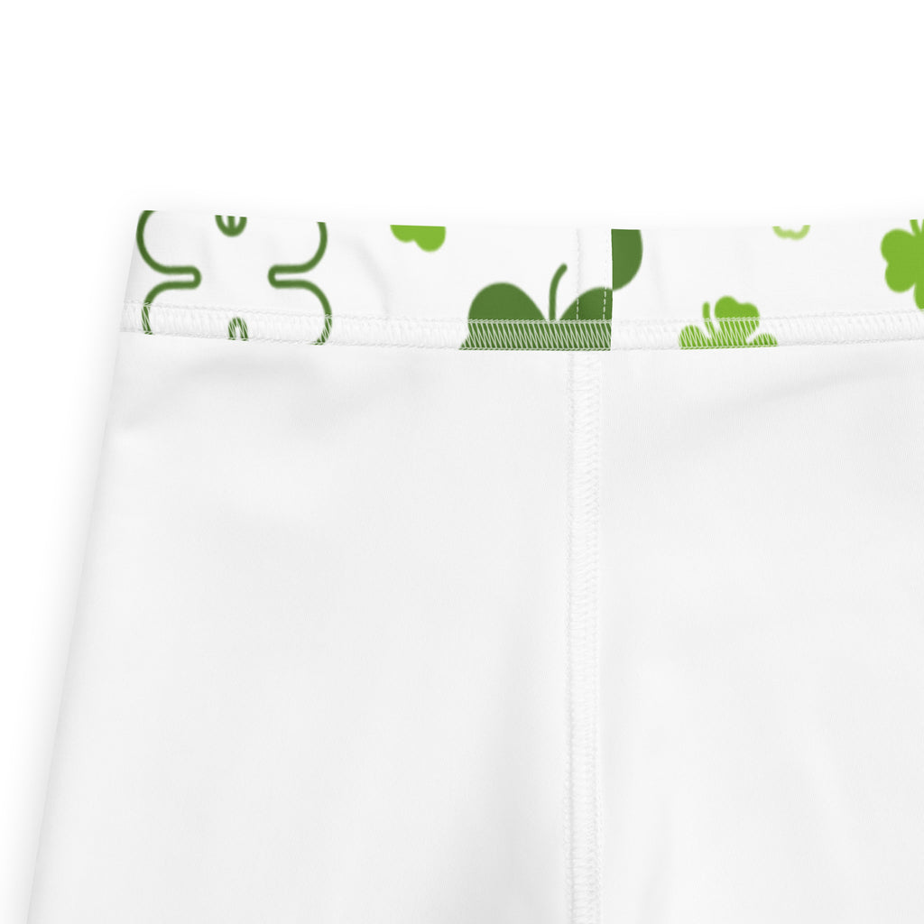 Girls white shamrock buttery soft leggings featuring white athletic shorts with green shamrock and leaf waistband pattern