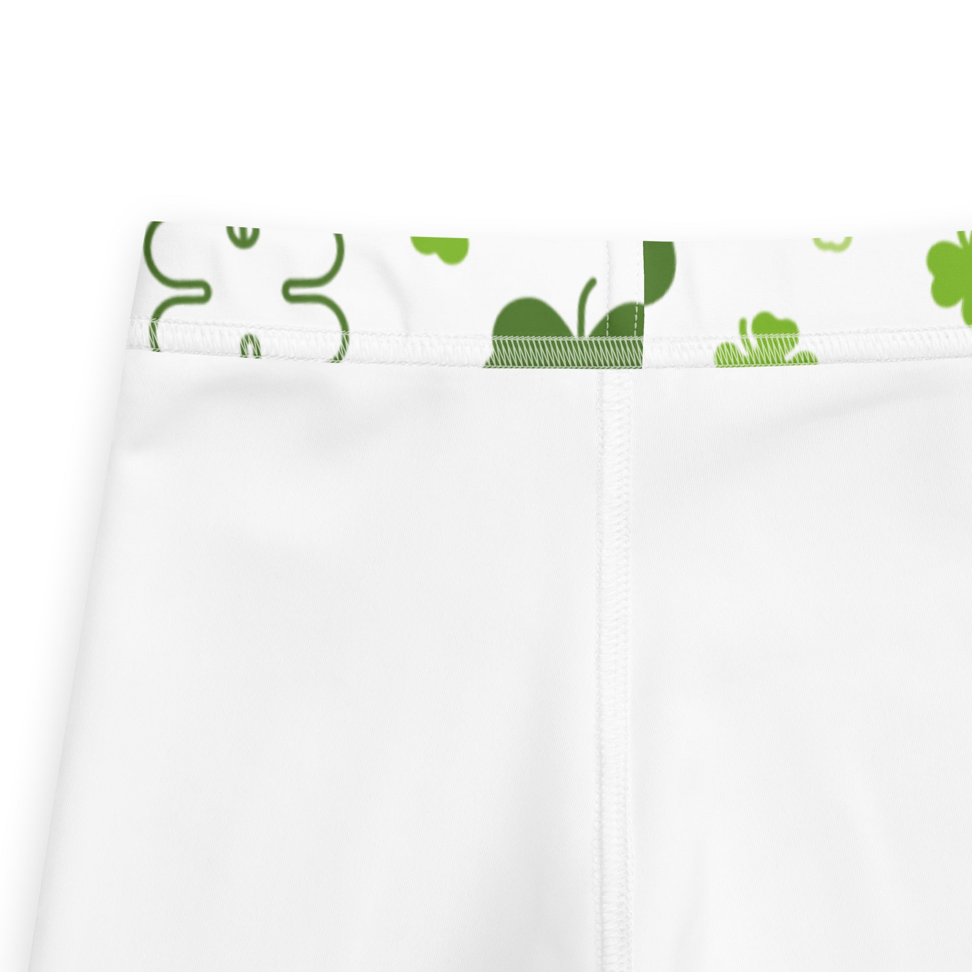 Girls white shamrock buttery soft leggings featuring white athletic shorts with green shamrock and leaf waistband pattern