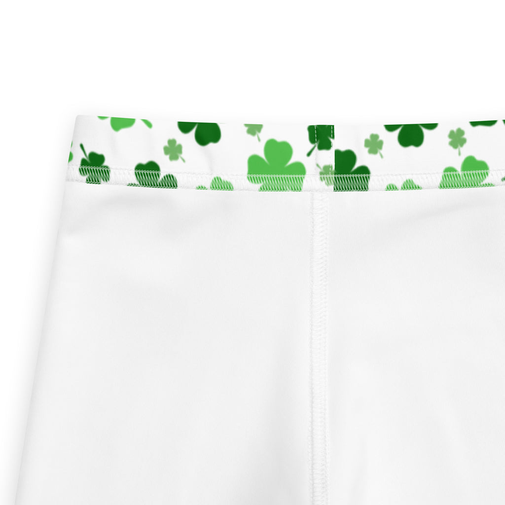 White girls buttery soft leggings with green shamrock print on waistband and white pants design