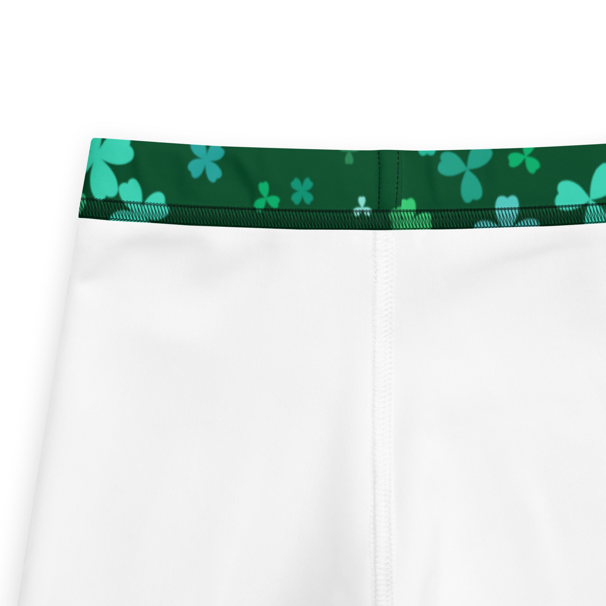 White athletic shorts with a green shamrock patterned waistband for girls featuring buttery soft fabric