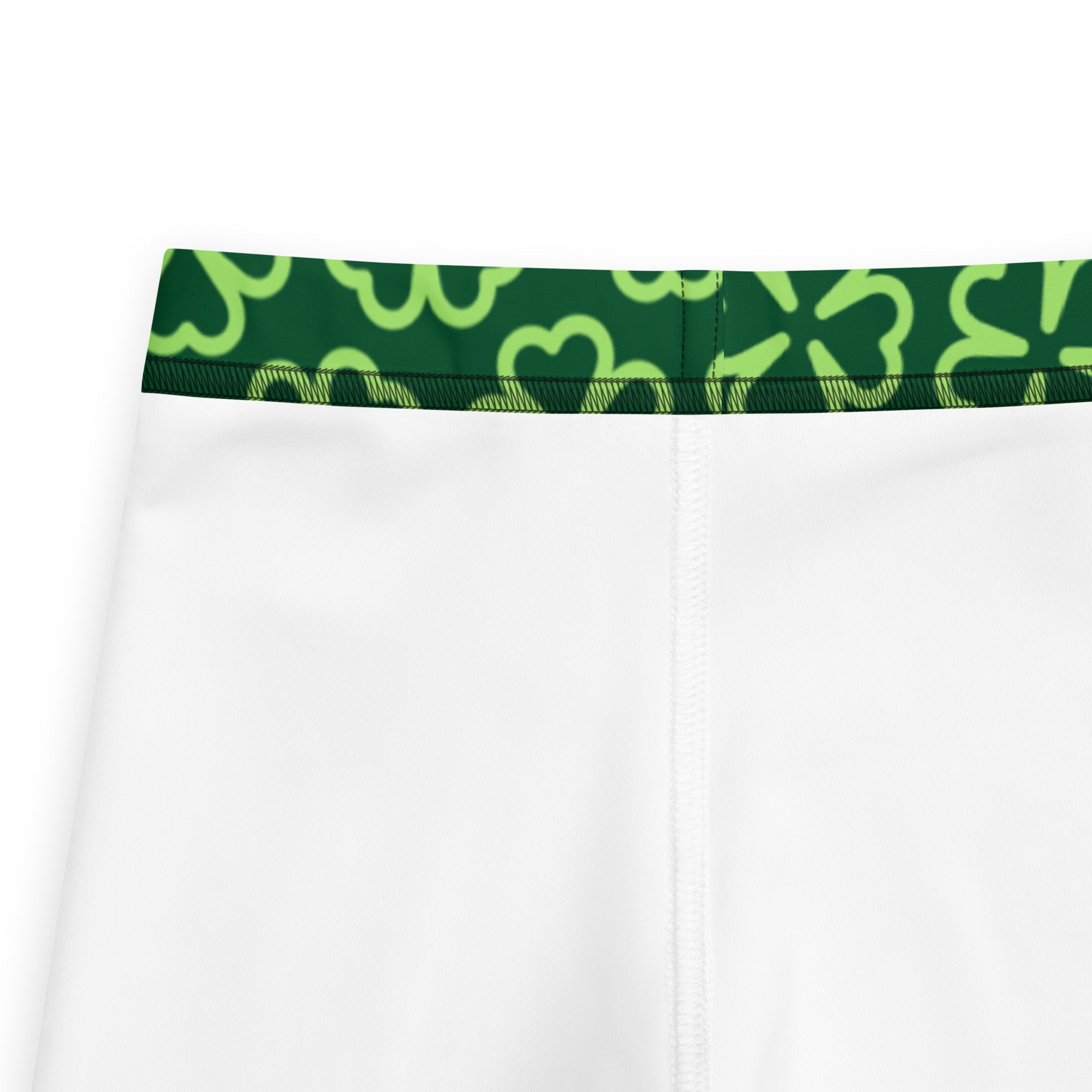 White athletic shorts with a green waistband and lime-green shamrock patterns complementing girls dark green shamrock leggings