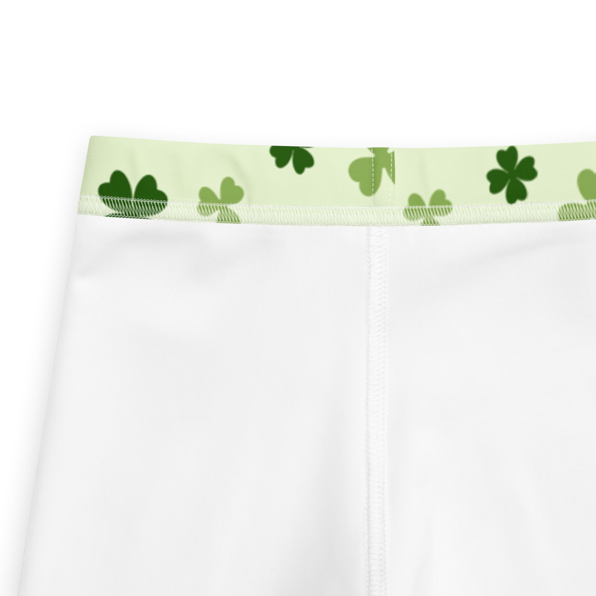 Girls light green shamrock buttery soft leggings with white fabric and light green waistband featuring dark green shamrocks