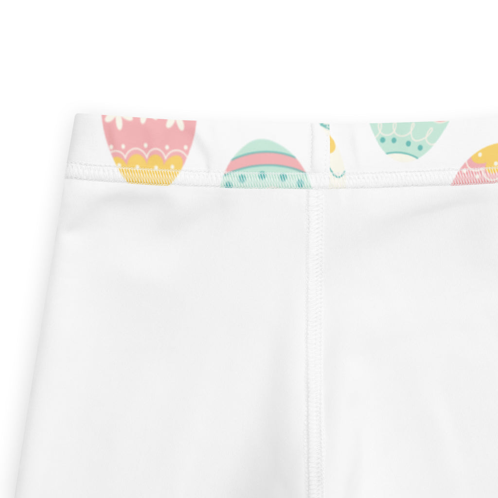 White girls buttery soft leggings with pastel cupcake and easter egg pattern along the waistband