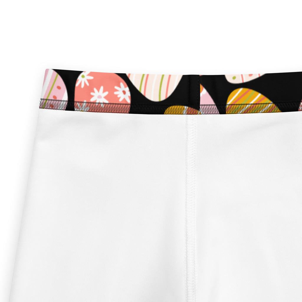 Girls bold Easter egg buttery soft white leggings with a colorful patterned waistband featuring black and pastel shapes