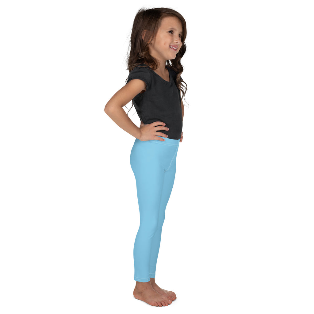 A young girl wearing light blue buttery soft leggings that are form fitting and comfortable for kids