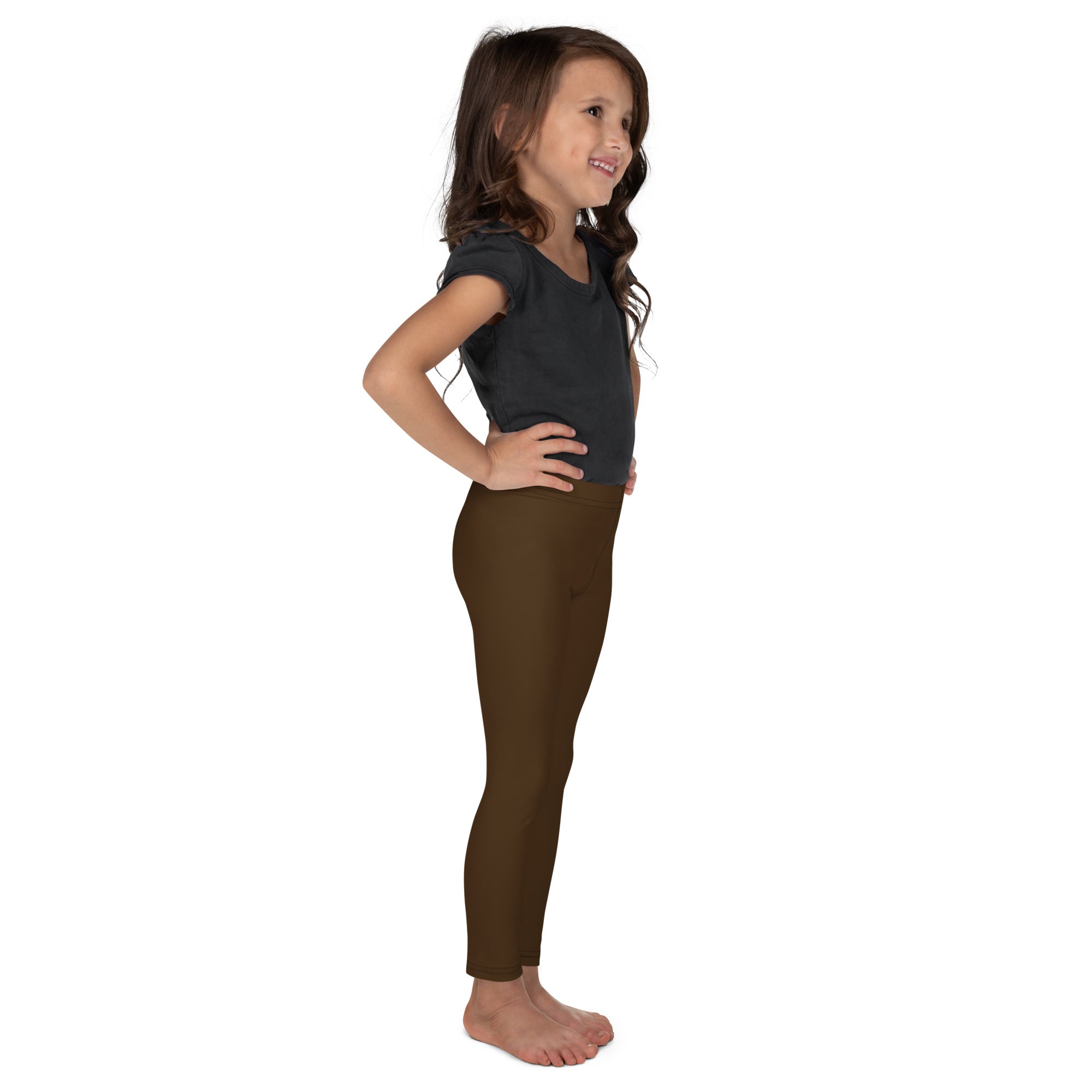 A child wearing dark olive green buttery soft kids leggings showing the front side