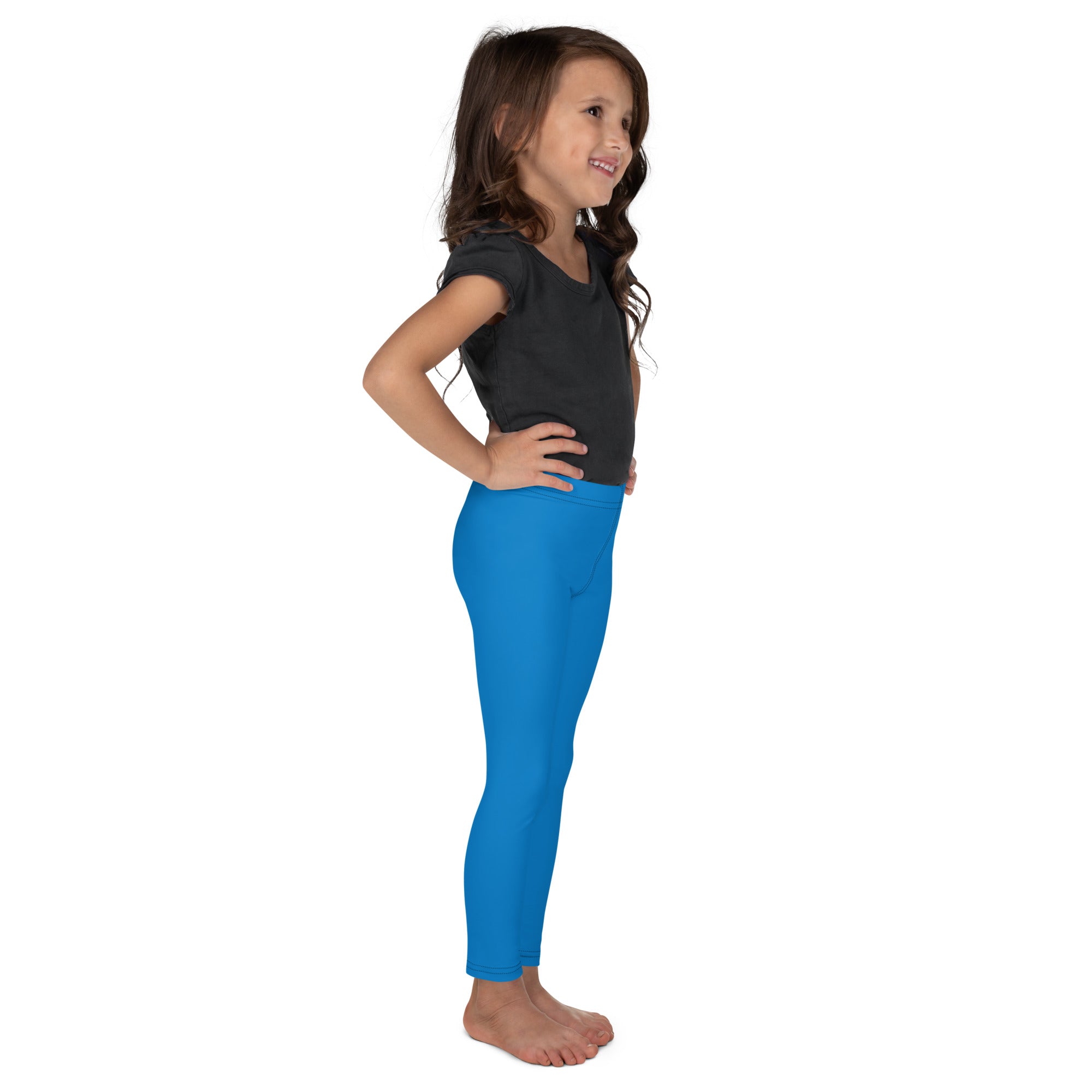 Young girl wearing bright blue kids buttery soft leggings that are form-fitting and comfortable for active wear
