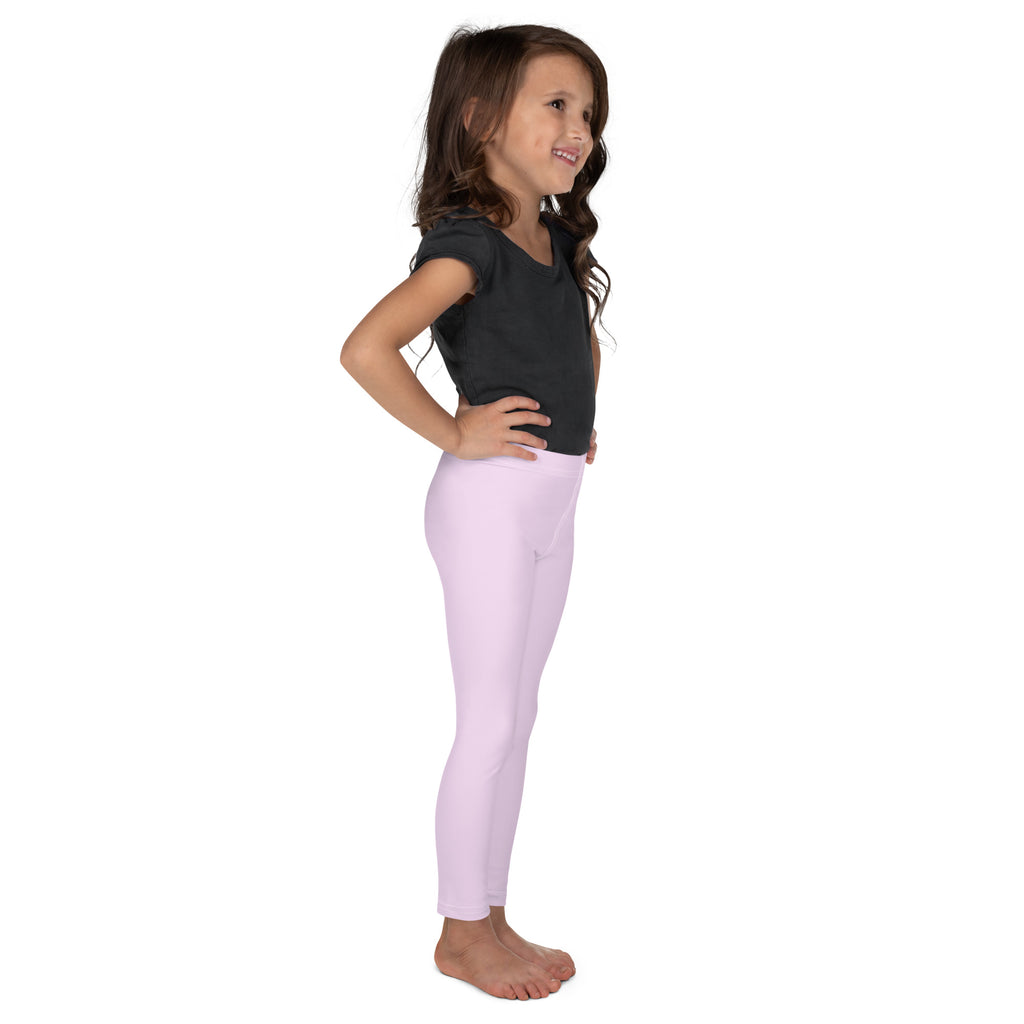 A young girl wearing light pink buttery soft form-fitting leggings designed for comfortable everyday wear