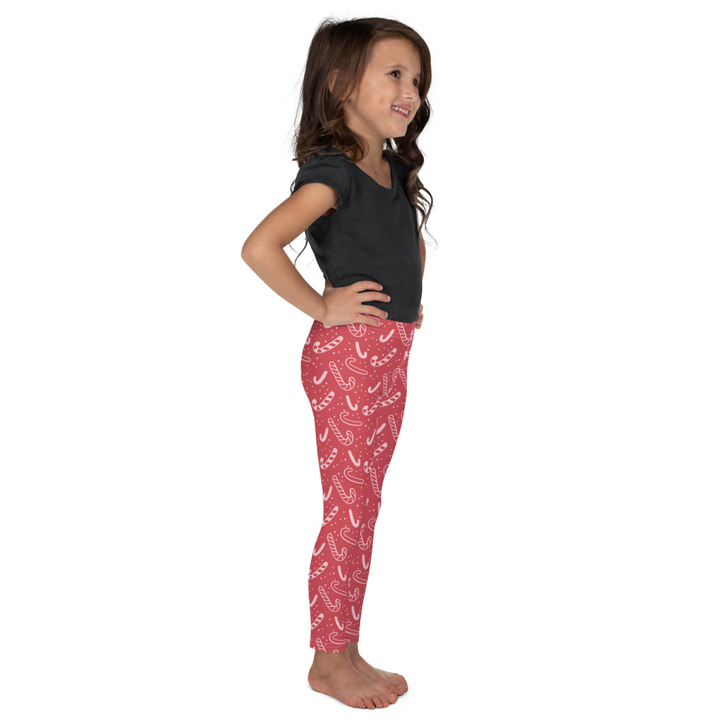 Girls red buttery soft leggings with a playful white candy cane pattern perfect for festive wear