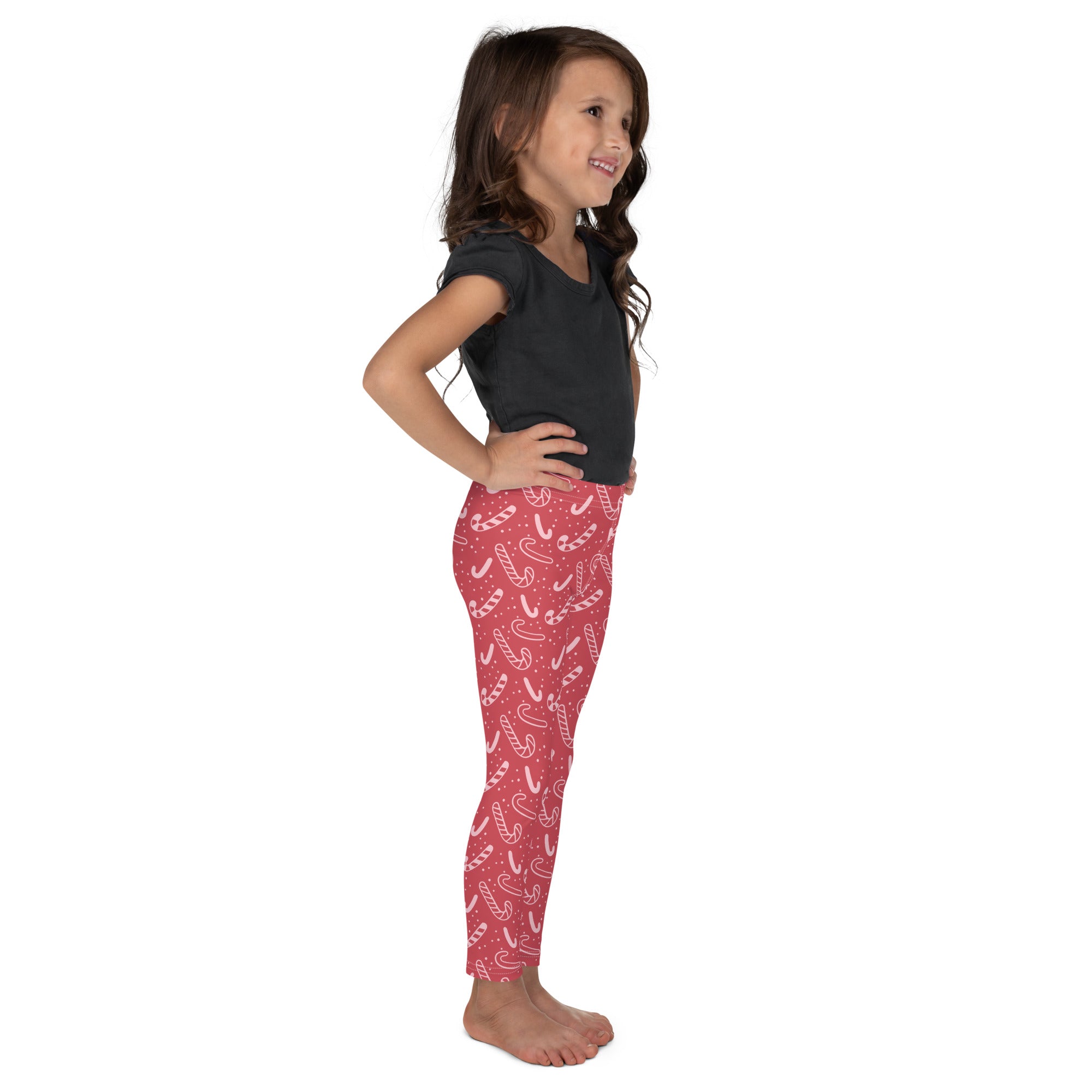 Girls red buttery soft leggings with a playful white candy cane pattern perfect for festive wear