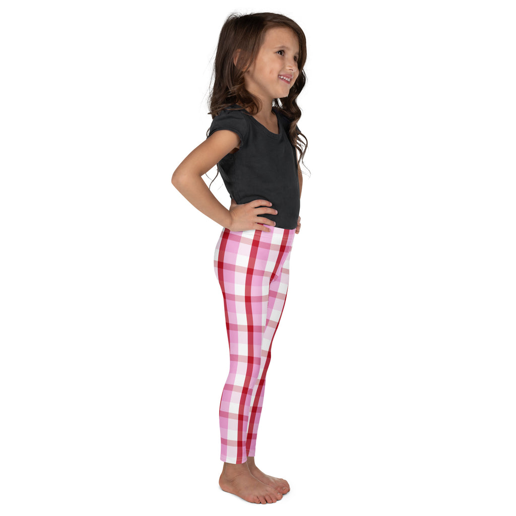 Girls pink and red plaid buttery soft leggings worn by a young girl showing front view