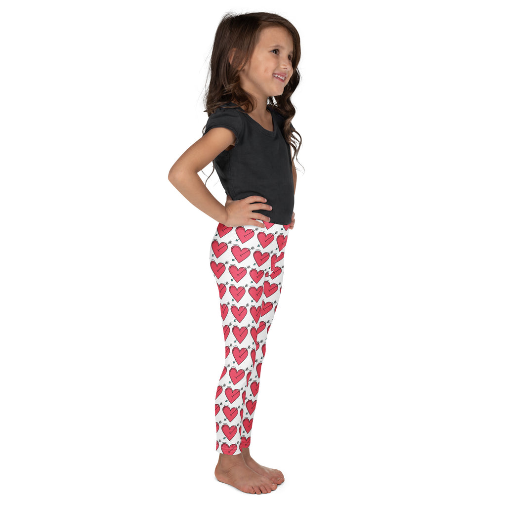 White girls buttery soft leggings with red arrow heart pattern outlined in black perfect for valentine’s day wear