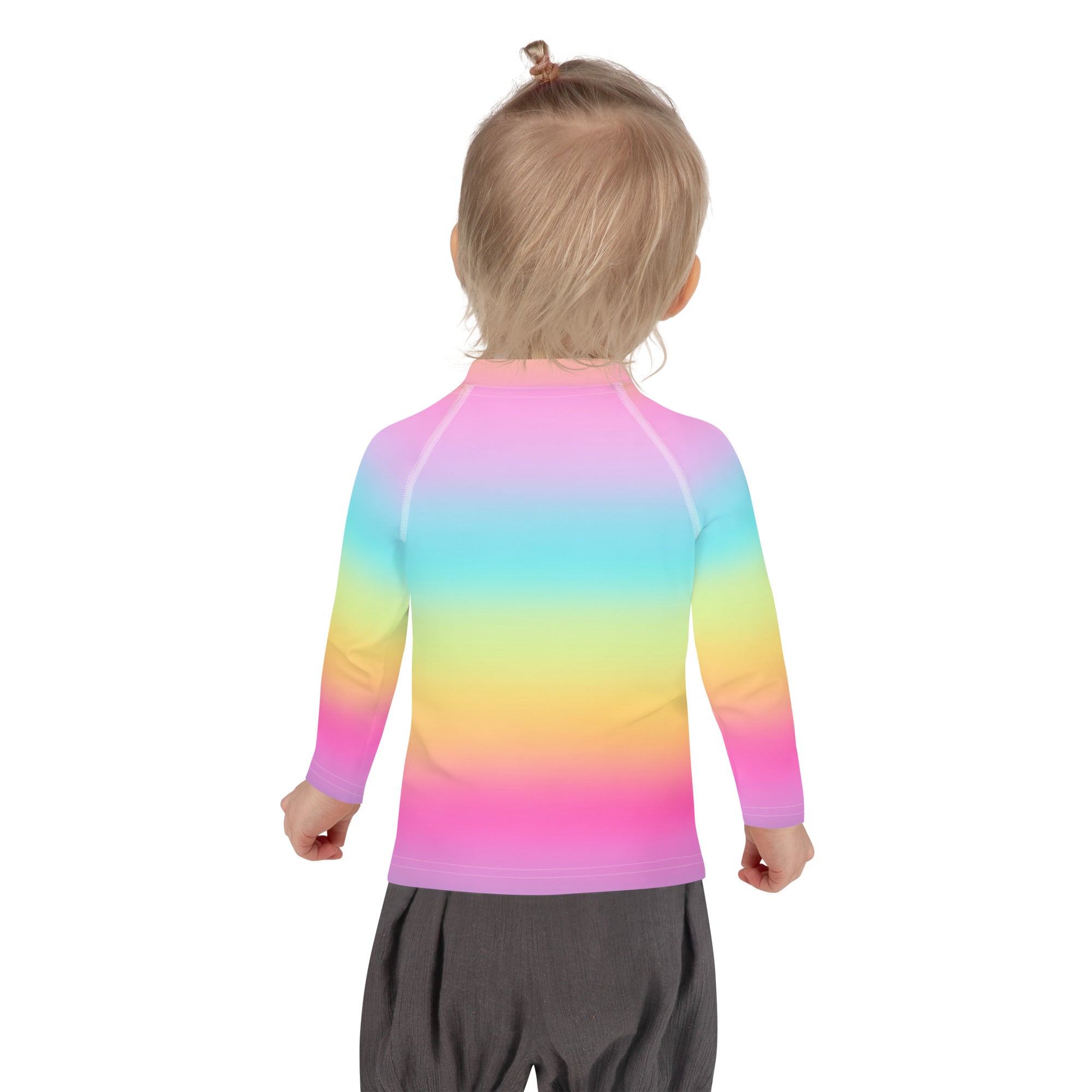 A child wearing a girls bright rainbow custom age birthday rash guard swim shirt with upf 50 plus smooth fabric