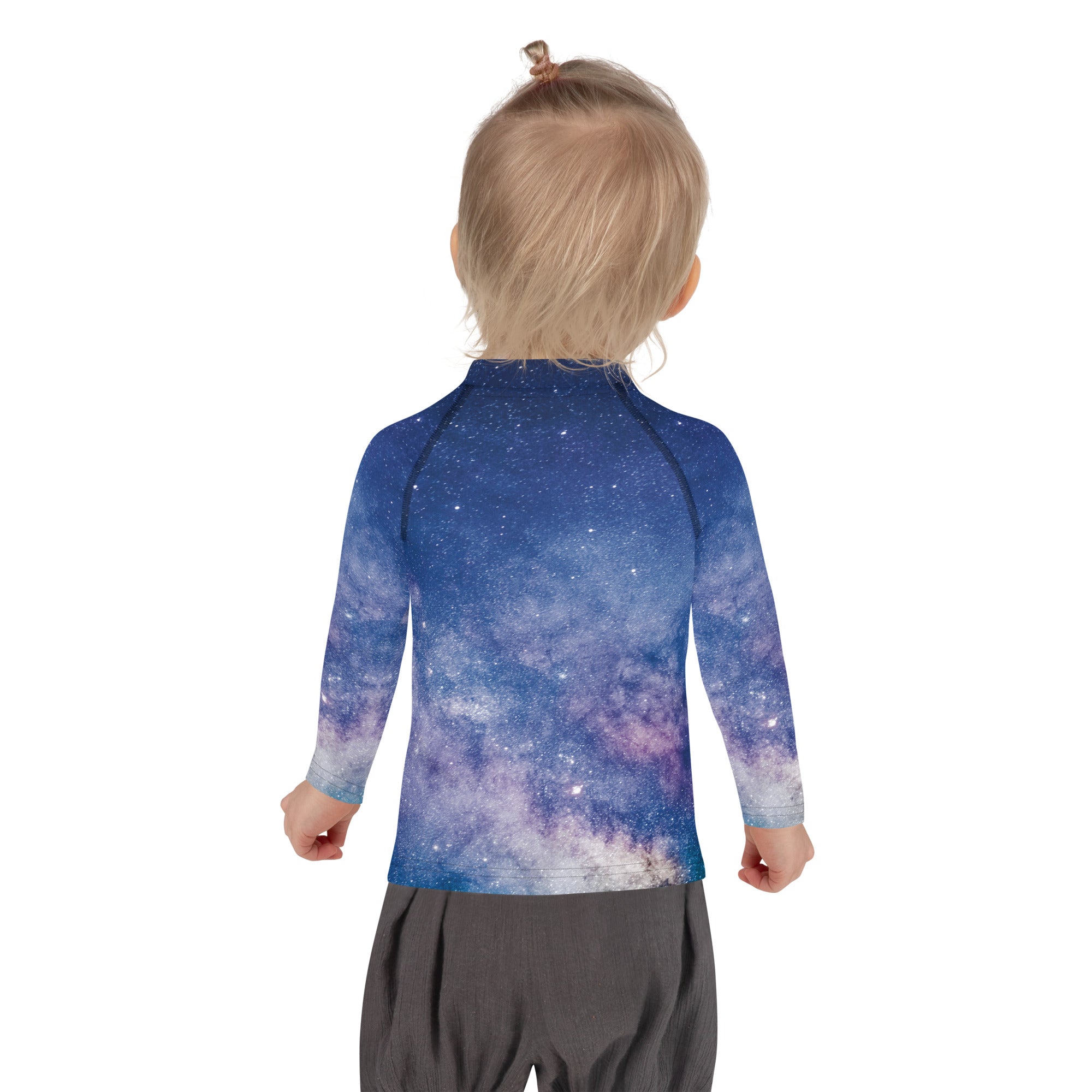 A girl wearing a blue and purple galaxy print long sleeve rash guard with upf 50 plus sun protection