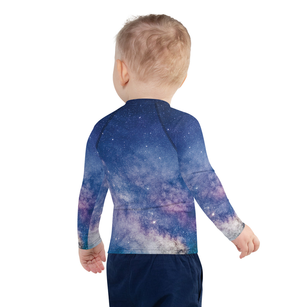 A child wearing a girls realistic galaxy long sleeve rash guard swim shirt with vibrant cosmic print and upf 50+ protection