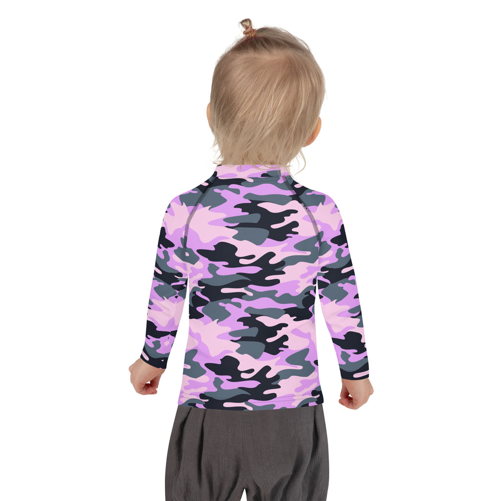 A child wearing a girls purple camouflage long sleeve rash guard swim shirt with UPF 50 plus in pink and gray