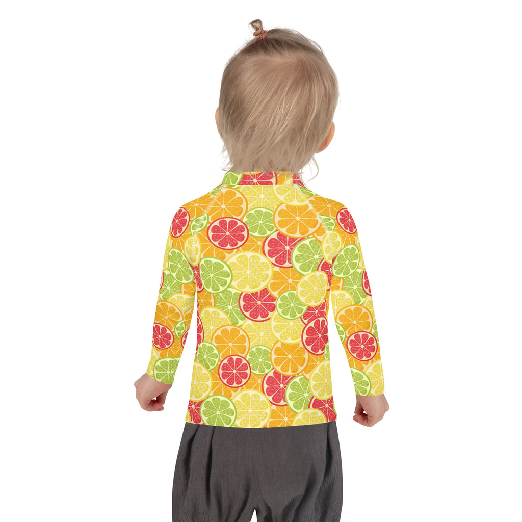A kids long sleeve rash guard swim shirt with upf 50 plus featuring a vibrant citrus fruit pattern on orange