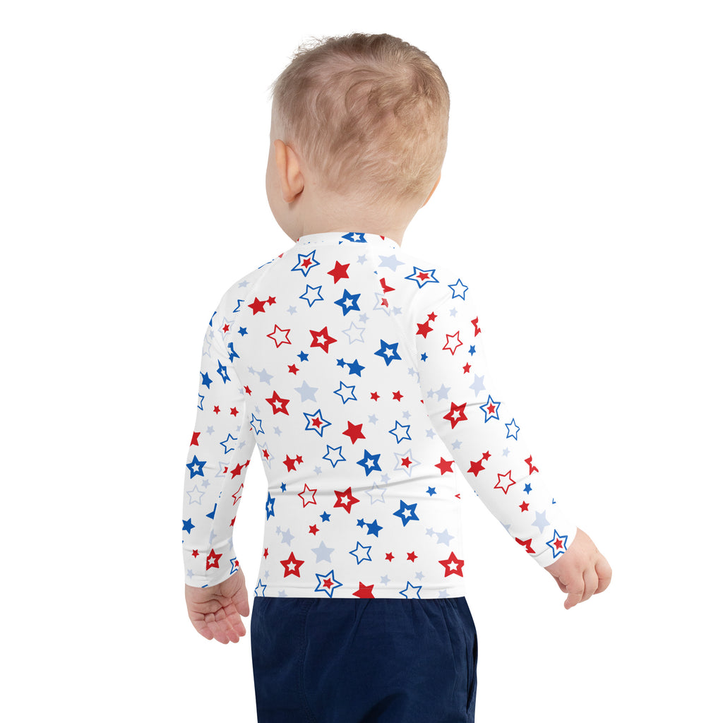 White long-sleeve baby rash guard swim shirt with red blue and silver stars and upf 50 plus sun protection