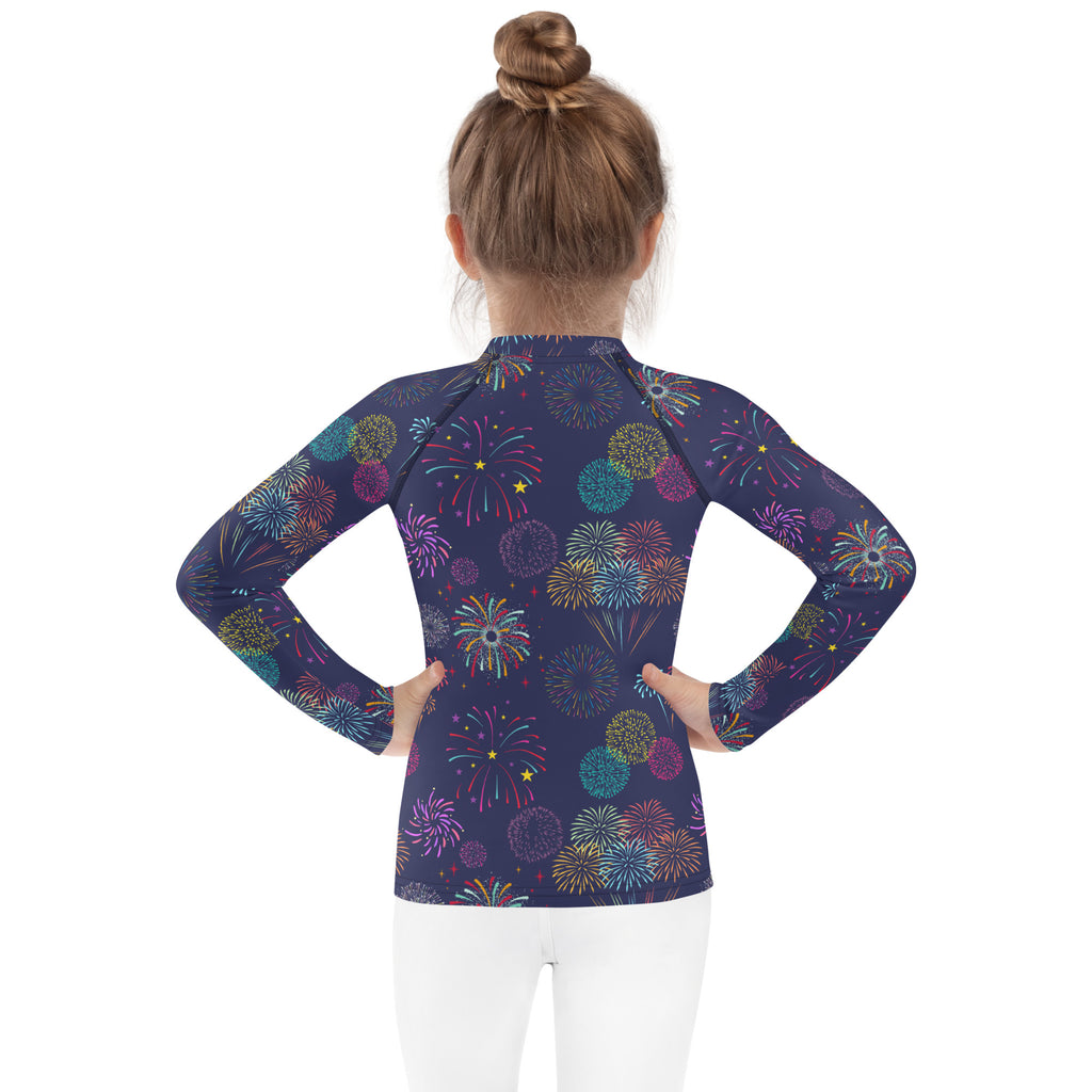 A navy blue kids long sleeve rash guard with vibrant multicolored fireworks pattern and UPF 50+ sun protection