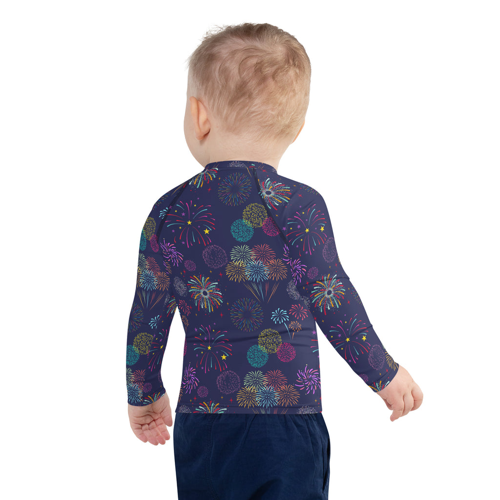 Kids navy blue long sleeve rash guard with vibrant multicolored fireworks pattern and upf 50 plus sun protection