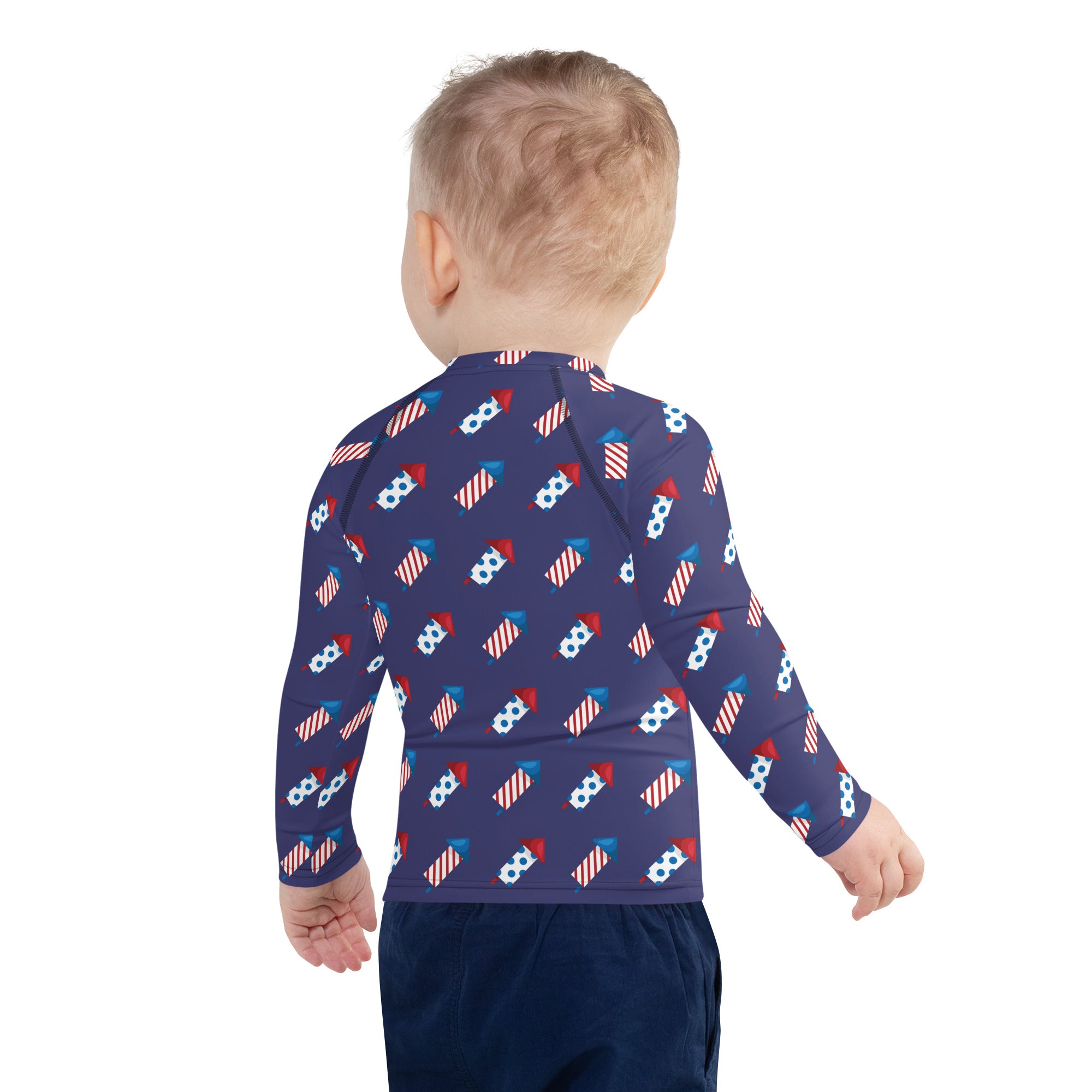 Navy blue kids firework rockets long sleeve rash guard swim shirt with red white and blue fireworks pattern and upf 50+