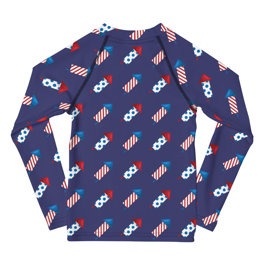 Navy blue kids long sleeve rash guard with red white and blue fireworks pattern and upf 50 plus sun protection