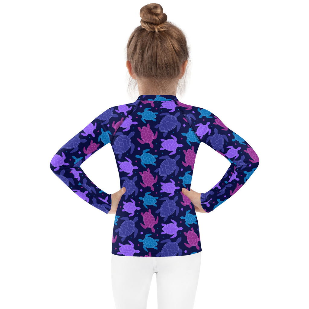 Girls purple sea turtle long sleeve rash guard swim shirt in navy blue with vibrant purple pink and teal sea turtles and upf 50+