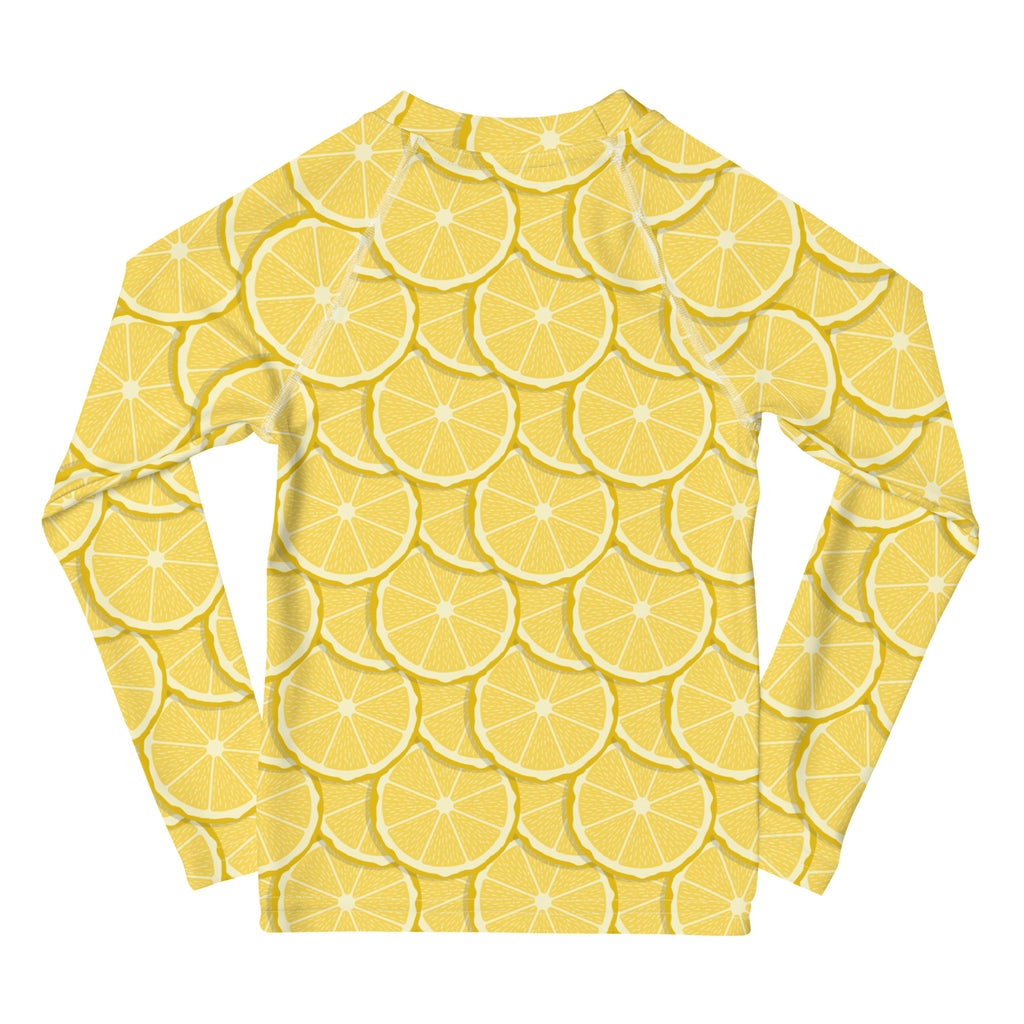 A vibrant yellow kids lemon long sleeve rash guard swim shirt with sliced lemon pattern and UPF 50 plus protection
