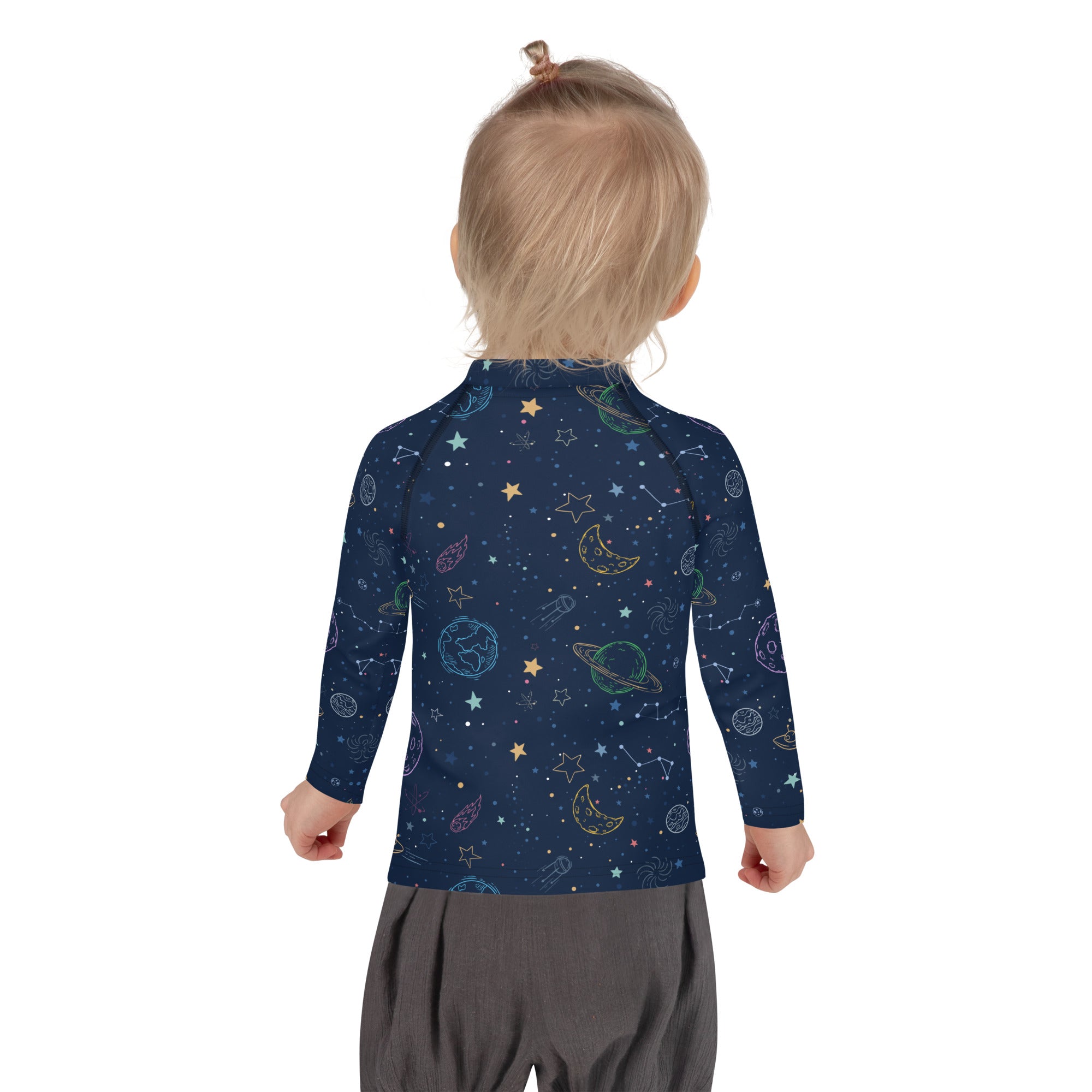 A child wearing a navy blue kids galaxy long sleeve rash guard swim shirt with colorful celestial designs and UPF 50+