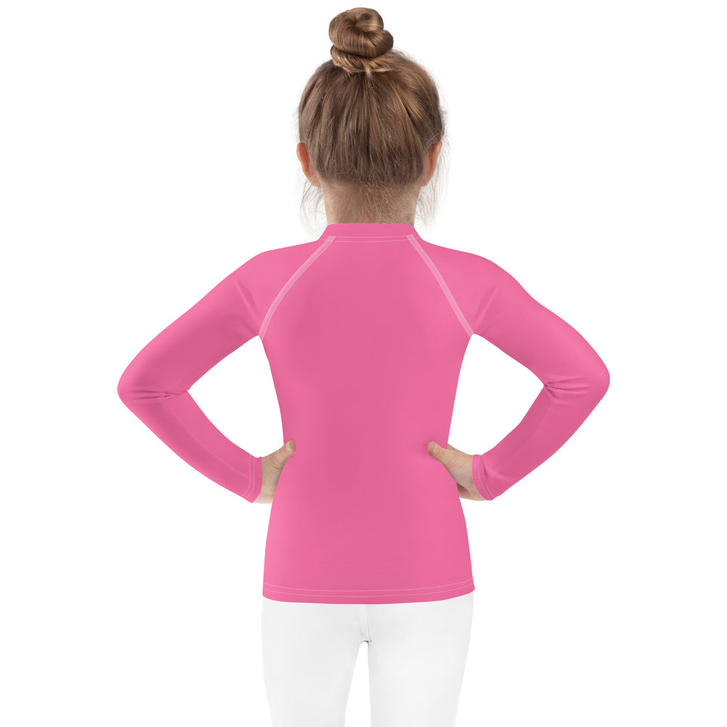 A vibrant pink girls long sleeve rash guard swim shirt with UPF 50 and seamless raglan sleeves