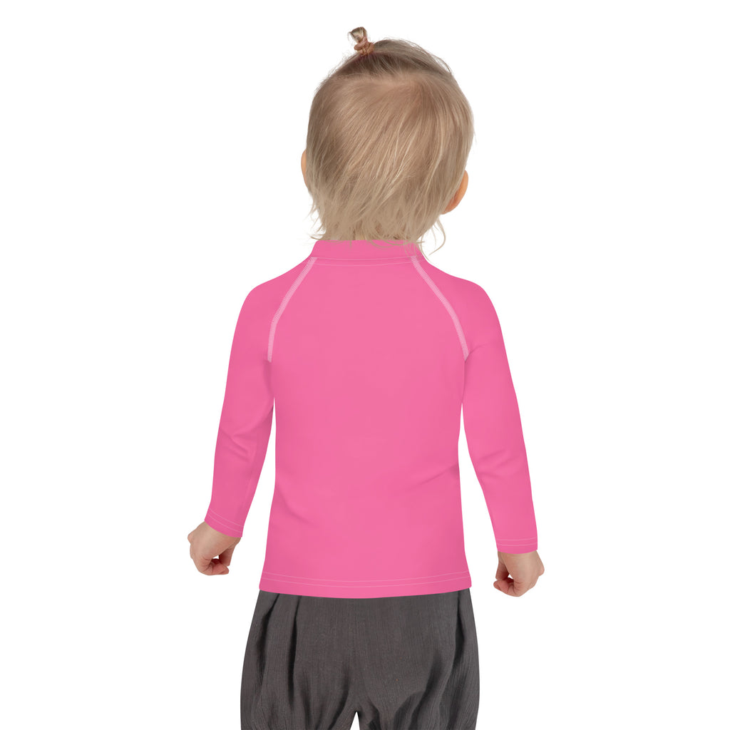 Girls pink long sleeve rash guard swim shirt with UPF 50 plus featuring subtle white seam detailing on shoulders and sleeves