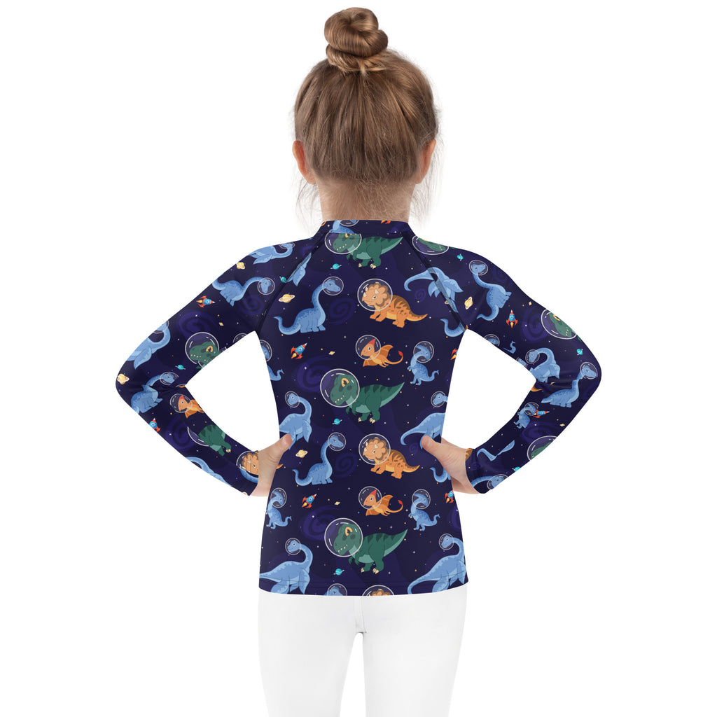 A navy blue kids long sleeve rash guard with UPF 50 plus featuring dinosaurs in astronaut helmets on a starry backdrop