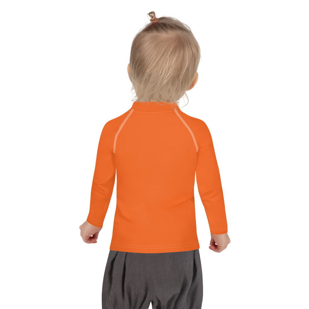 Kids orange long sleeve rash guard swim shirt with subtle light seam detailing and UPF 50 plus sun protection