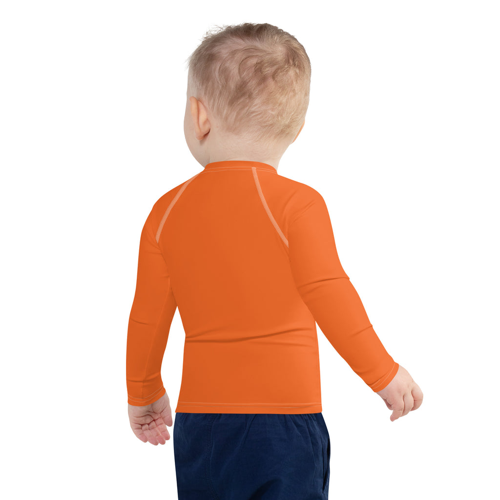Kids orange long sleeve rash guard swim shirt with upf 50 plus featuring subtle white seam detailing