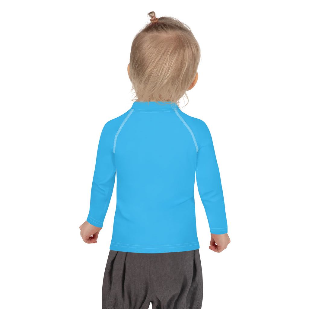 Bright blue kids long sleeve rash guard with subtle gray seam detailing and upf 50 plus for sun protection