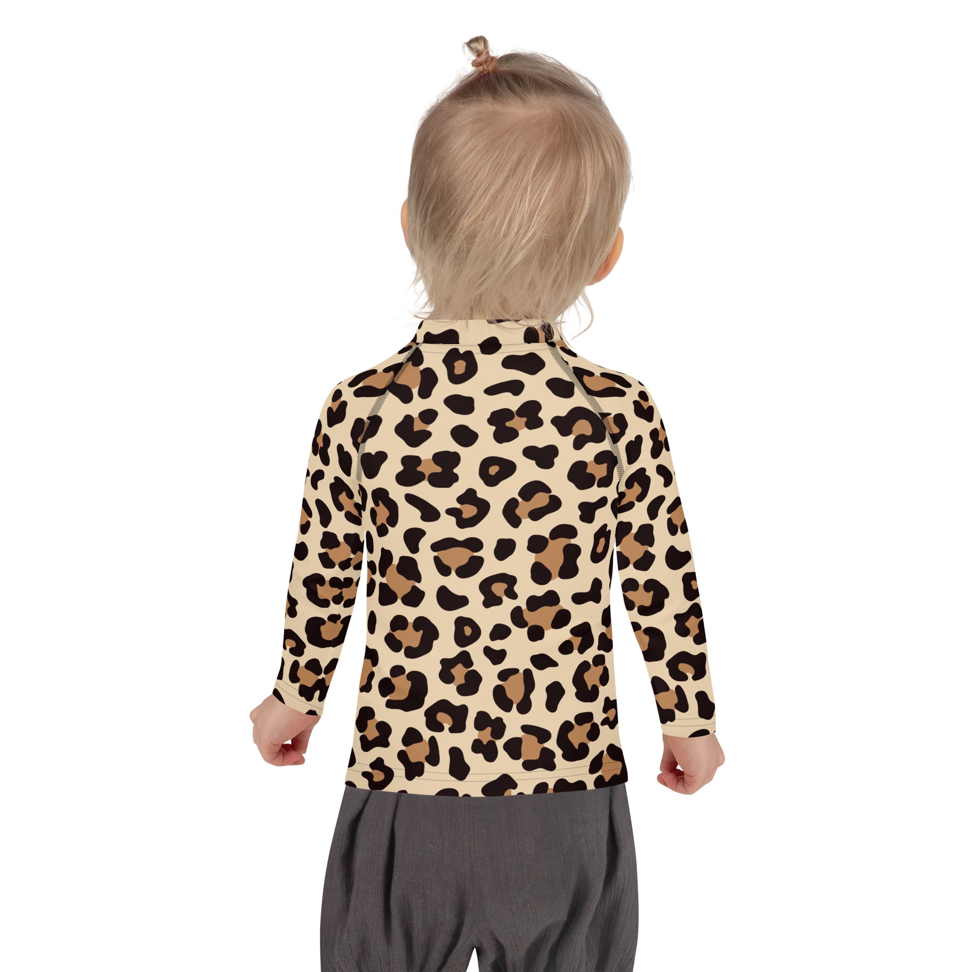 A child wearing a kids leopard print long sleeve rash guard swim shirt with upf 50 beige and black spots