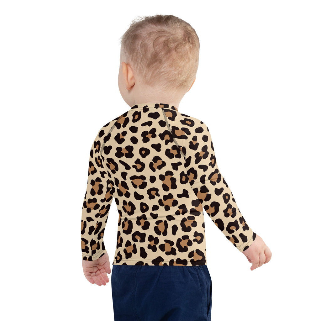 A child wearing a beige and brown leopard print long sleeve rash guard swim shirt with UPF 50 plus protection