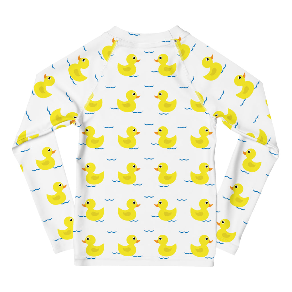 White long sleeve rash guard with yellow rubber ducks and blue waves designed for kids with upf 50 plus protection