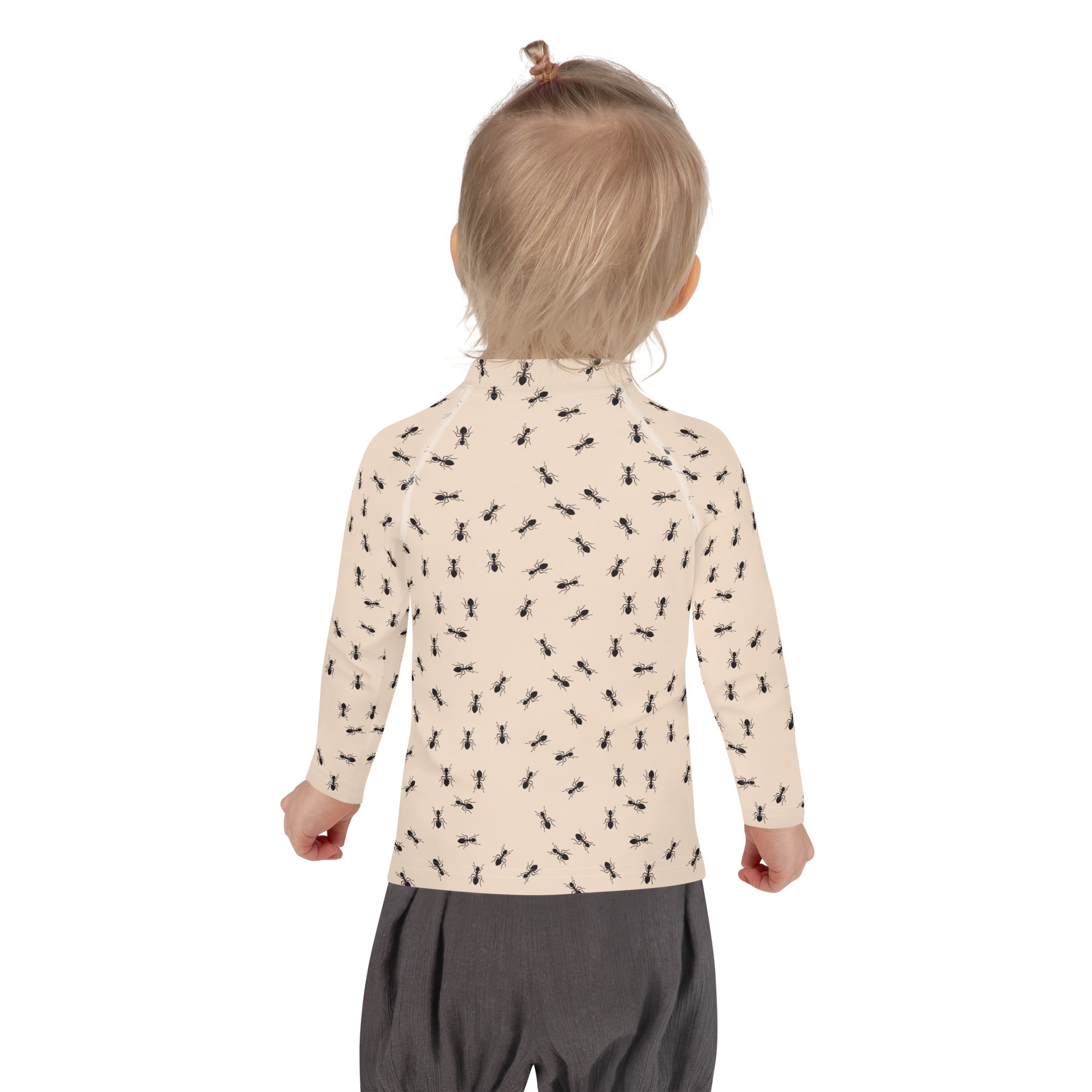 Beige long-sleeved toddler rash guard swim shirt with black ant print and upf 50 plus sun protection
