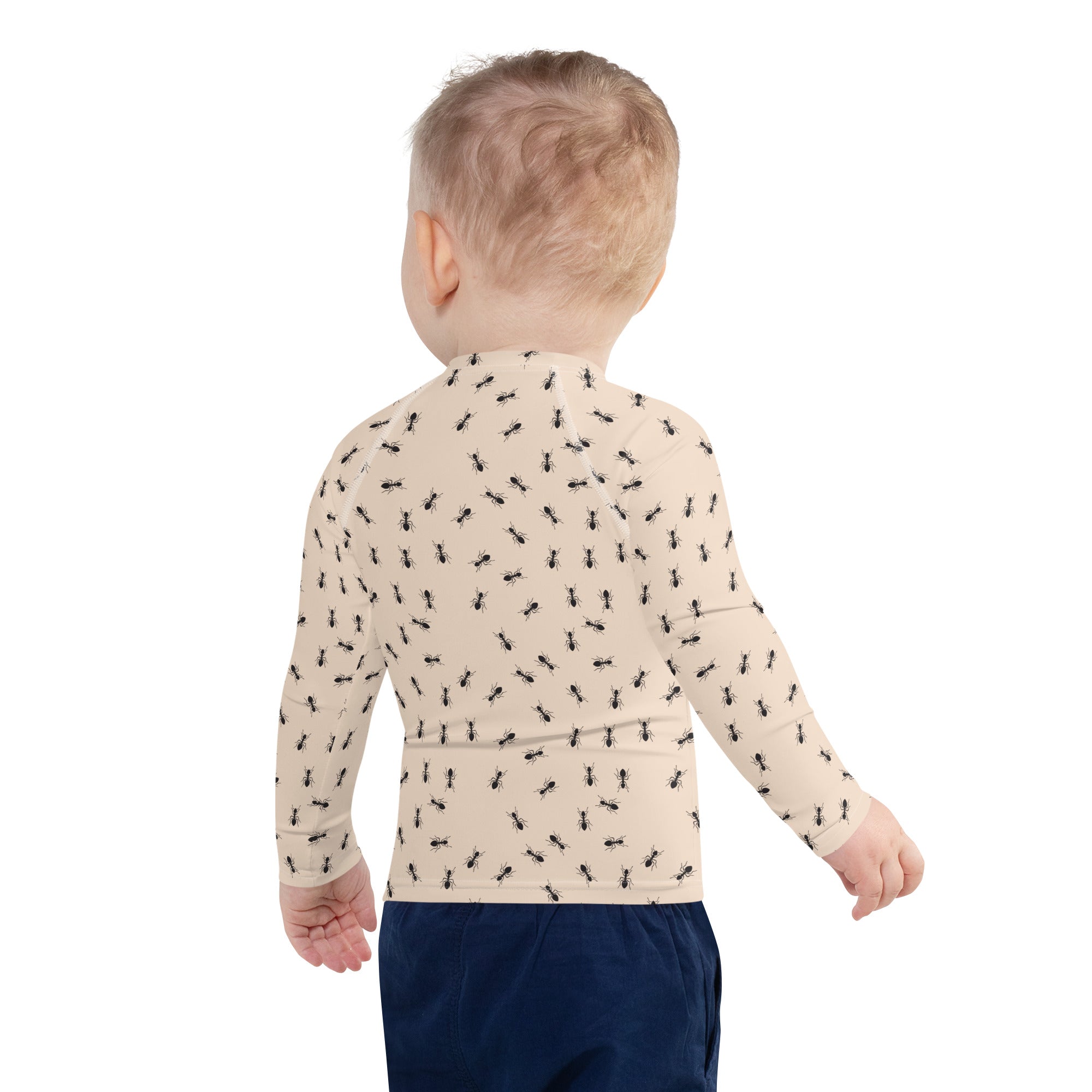 Beige long-sleeved kids rash guard swim shirt with black ant pattern and UPF 50+ sun protection