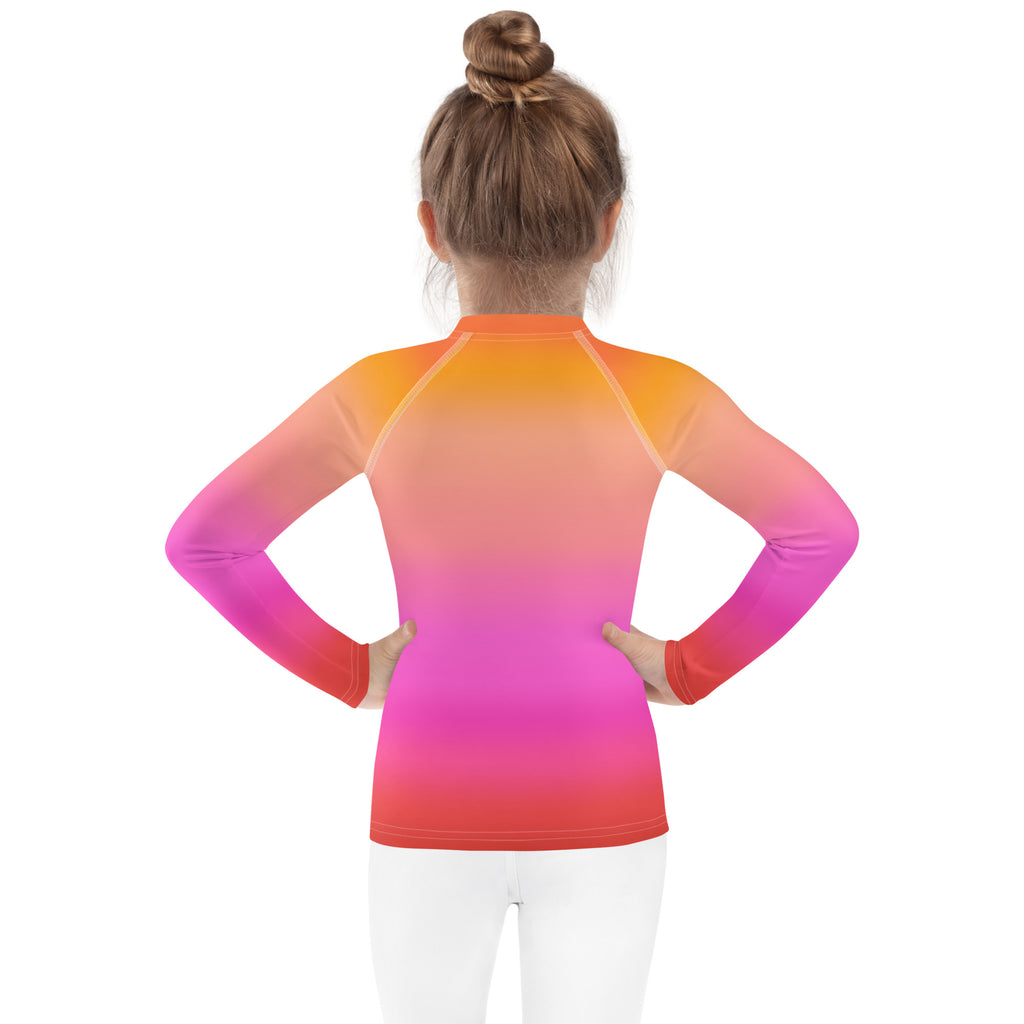 Girls sunset ombre long sleeve rash guard swim shirt in orange to pink gradient made of stretchy fabric with upf 50+ protection